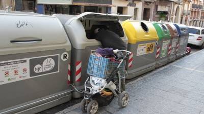Un rodamón regira un contenidor de la brossa, al centre de Tarragona, en una imatge d´arxiu. Foto: pere ferré / dt