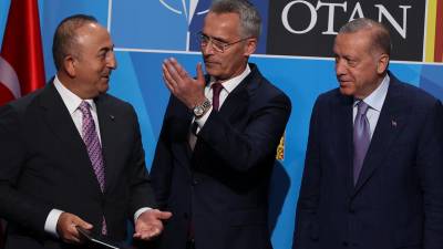 El secretario general de la OTAN, Jens Stoltenberg (c), junto al ministro de exteriores de Turquía, Mevlüt Çavusoglu (i), y el presidente Recep Tayyip Erdogan (d), tras la firma de un acuerdo para desbloquear el veto turco al acceso de Finlandia y Suecia a la OTAN. Foto: Efe