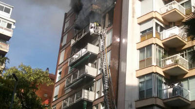 Pla general d'un camió de bombers davant de l'edifici incendiat a Barcelona. Foto: ACN