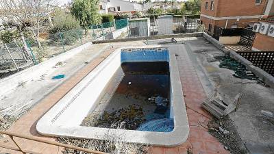 En el interior del edificio hay una piscina en estado de abandono y rodeada de escombros. FOTO: PERE FERRÉ