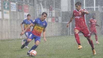 Nil Jiménez trata de frenar la carrera de un futbolista del Andorra. foto: fc andorra