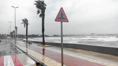 El passeig i la platja de l’Arenal de l’Ampolla, ahir afectats per la llevantada. FOTO: CÈSAR CERVERA