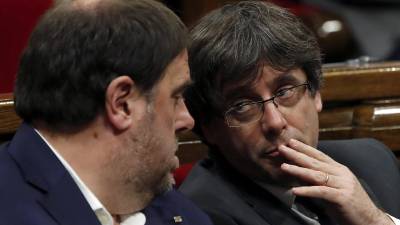 El presidente de la Generalitat, Carles Puigdemont, conversa con el vicepresidente, Oriol Junqueras