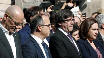 El presidente de la Generalitat, Carles Puigdemont (2d), la alcaldesa de Barcelona, Ada Colau (d), y los consellers de Presidencia, Jordi Turull (2i) y de Relaciones Exteriores, Raül Romeva (i), durante la concentración que se ha celebrado este mediodia en la plaza de Sant Jaume. FOTO: EFE