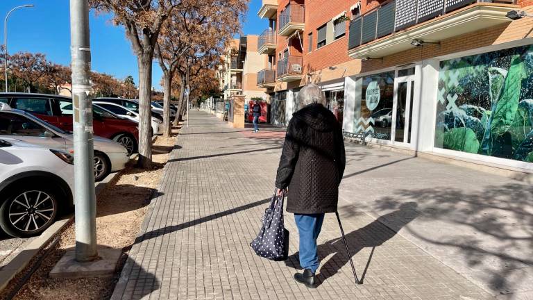 Una anciana pasea a lo largo de Mas de Clariana con la compra apoyada sobre su bastón, sin ningún banco en los alrededores. foto: alba mariné