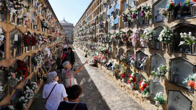 Varias personas visitando, en el Cementiri de Tarragona, los nichos de sus familiares y seres queridos fallecidos. Foto: Pere Ferré