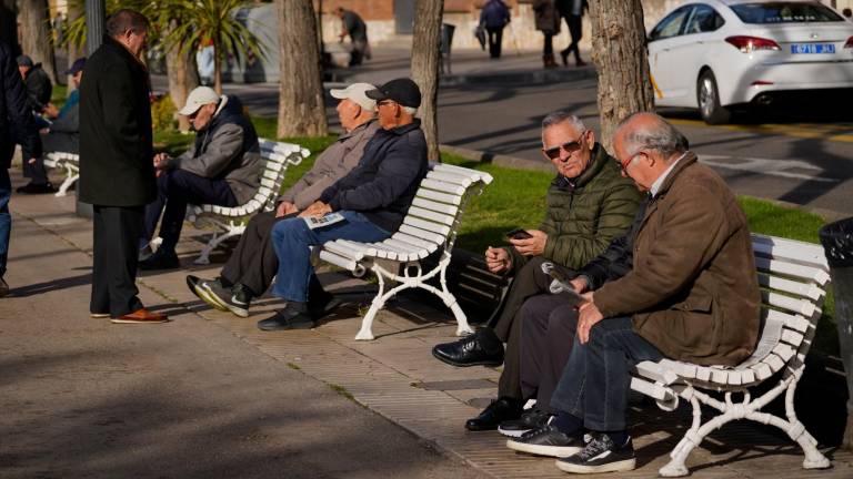 Personas mayores sentadas en bancos de Tarragona. Foto: Marc Bosch