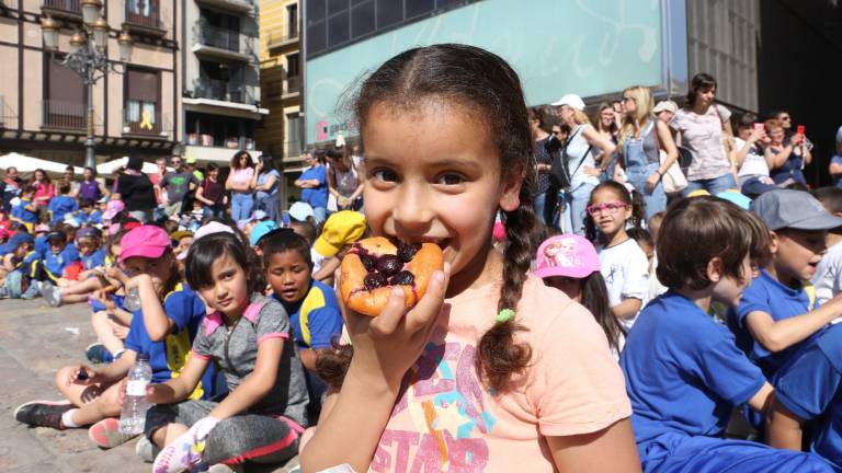 Els nens i nenes, presents al Mercadal, van devorar la tradicional coca amb cireres FOTO: Alba Mariné