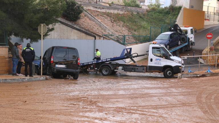 Una grúa retira uno de los vehículos afectados en una de las rotondas próximas al barranco de La Borrasca, en L'Ampolla. FOTO: ACN
