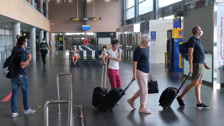Viajeros cargados con sus maletas dentro la terminal, ayer al mediodía, coincidiendo con algunos desembarques de Ryanair. FOTO: FABIÁN ACIDRES