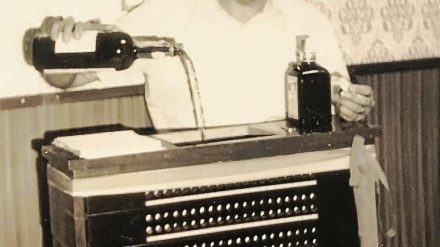 L’Antonio Tovar, abocant licor dins de la centraleta telefònica a la seu del passatge de Taquígraf Martí. FOTO: Arxiu Teresa Tovar