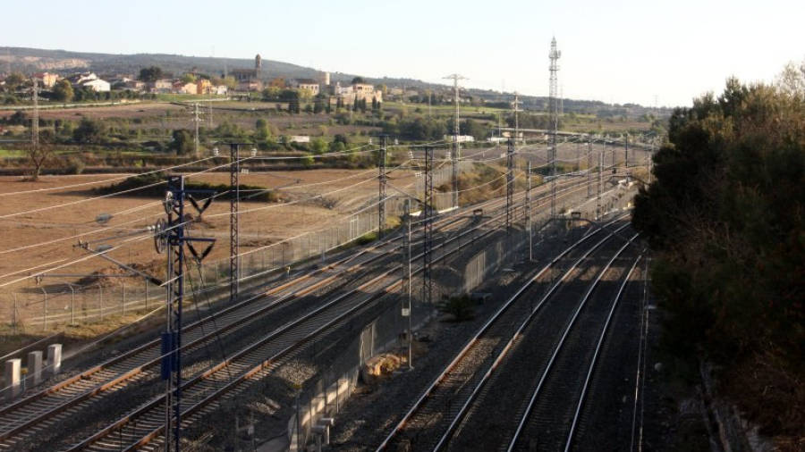 Imatge de les vies del tren a la sortida de Vilafranca del Penedès en paral·lel a les línies del TGV, amb el nucli de Moja al fons. Foto: ACN