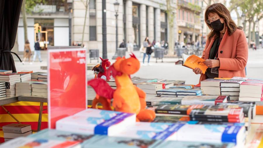 Una dona fullejant un llibre ahir en una parada a Barcelona. firma: efe