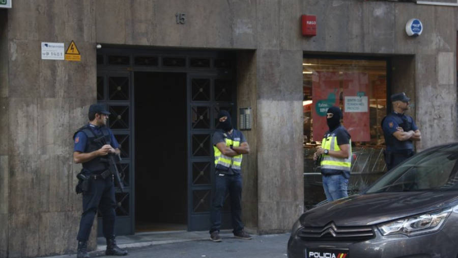 Els agents de la policia espanyola custodien el portal on ha estat detingut el presumpte membre de la cèl·lula jihadista a Barcelona. Imatge del 28 de setembre del 2016.