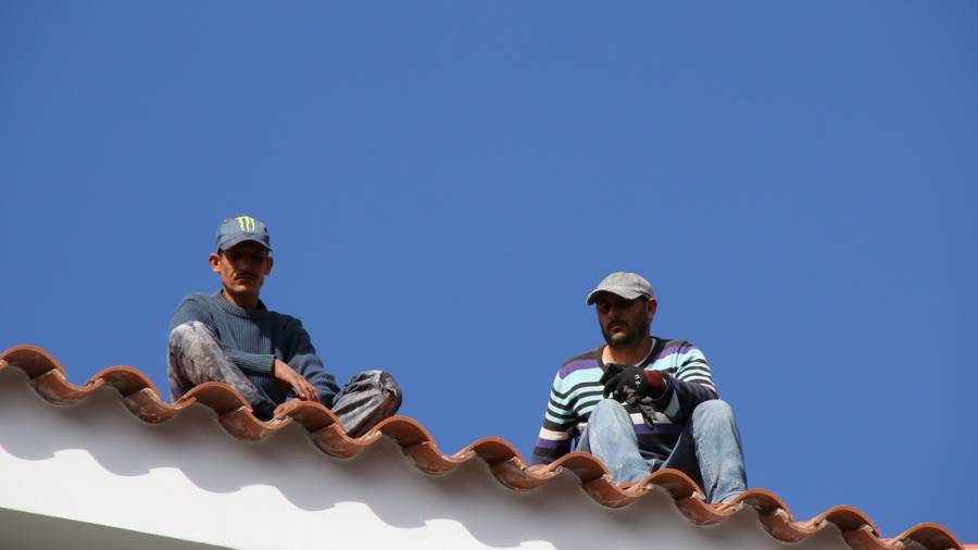 Los dos trabajadores en el tejado del hotel Best san Diego, en la calle Penedès de Salou