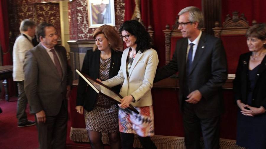 Conxita Rovira, la hermana del fallecido, recogió el reconocimiento de la mano del alcalde. Foto: Pere Ferré