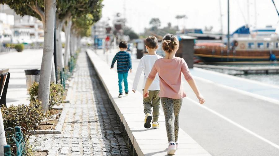 magen de tres niños caminando junto al puerto de Cambrils. FOTO:Alba Mariné