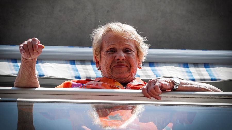 Una mujer saluda desde un piso tutelado para mayores en San Sebastián. FOTO: EFE