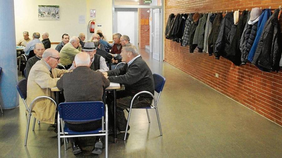Pensionistas jugando partidas al dominó por la tarde en el hogar del jubilado de Bonavista. Foto: Lluís Milián