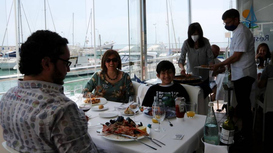 Pla general d'una família dinant en un dels restaurants de la zona marítima de l'Ampolla. Foto: ACN