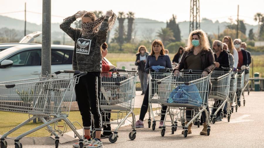 Varias personas haciendo cola ayer miércoles para entrar en un supermercado de Ibiza para hacer la compra. FOTO: EFE