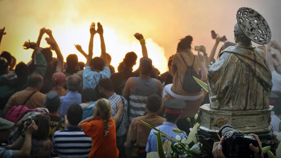 El bust de Sant Pere, d’esquena, amb la multitud de gent mirant com peta la Tronada de la Festa Major. FOTO: ALFREDO GONZÁLEZ