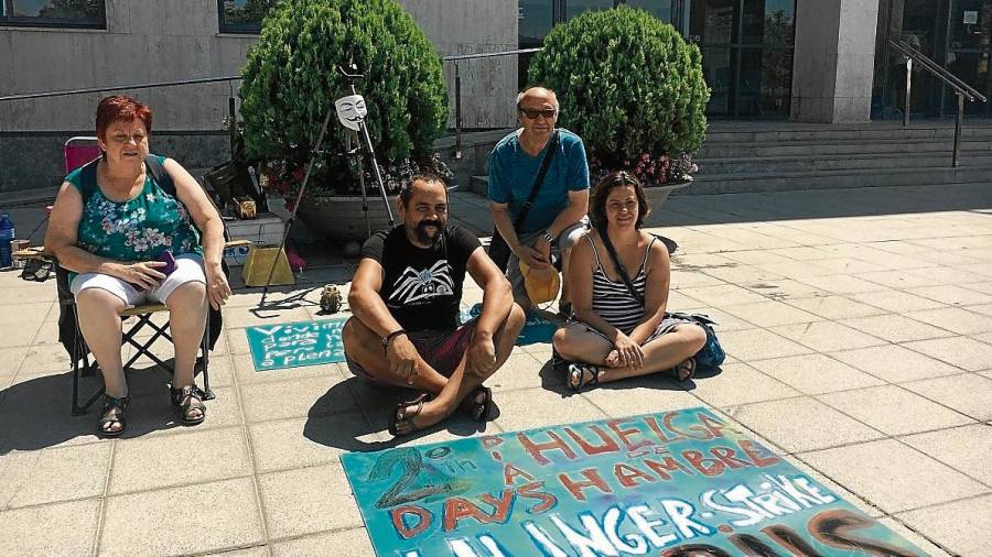 Jorge Fernández, con camiseta negra, acompañado por un grupo de simpatizantes que apoyan la huelga de hambre que inició el pasado jueves por la mañana en la plaza del ayuntamiento. FOTO: Cristina Sierra