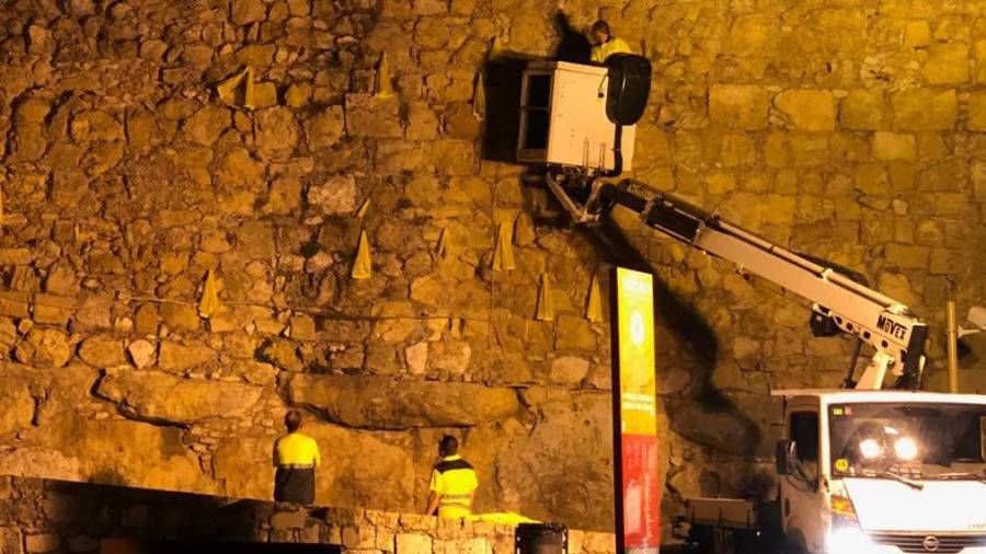 Momento de la retirada de los lazos amarillos de la Muralla de Tarragona. Cedida