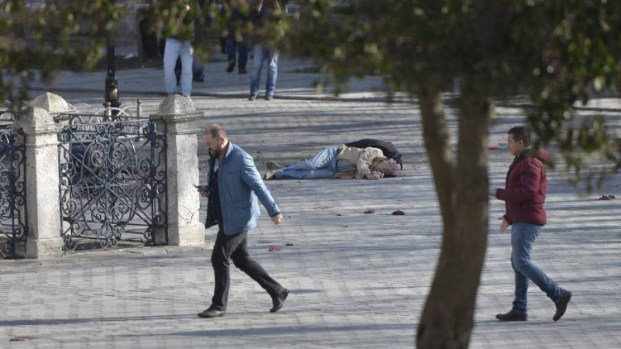 El cadáver de una víctima yace en el suelo tras registrarse una fuerte explosión en las inmediaciones de la Mezquita Azul, en el turístico distrito de Sultanahmet, centro de Estambul (Turquía), el 12 de enero de 2016. Al